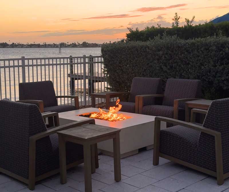 A spacious guest suite with a private balcony and waterfront view at our residential wellness immersion.